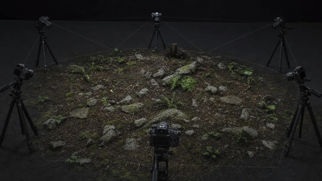 A ground surface being photographed from multiple angles with a camera on a rig under even lighting, illustrating a photogrammetry capture setup